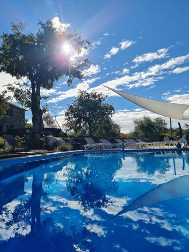 a swimming pool with the sun reflecting on the water at Boutique Resort OSMA - Adults Only in Malinska