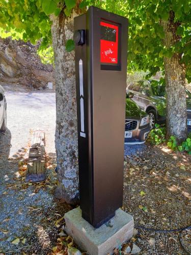 a post box sitting next to a tree at Los Pozos de la Nieve in Constantina