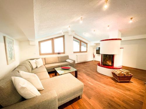 a living room with a couch and a fireplace at Apartment Auszeit Sommercard inklusive in Hollersbach im Pinzgau