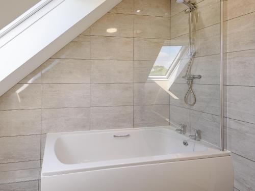 uma banheira branca na casa de banho com uma janela em Dawson Park 3 - Uk12662 em Mablethorpe