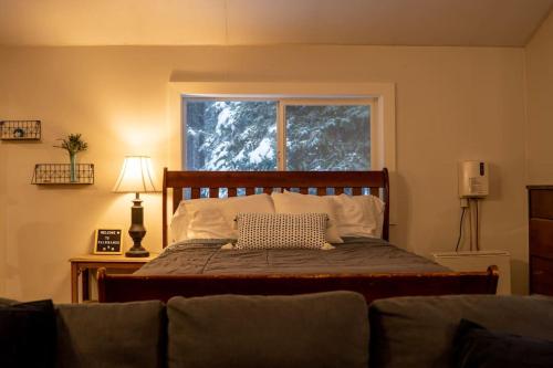 1 dormitorio con 1 cama, ventana y sofá en Cozy Studio Apartment With Sauna, en Fairbanks