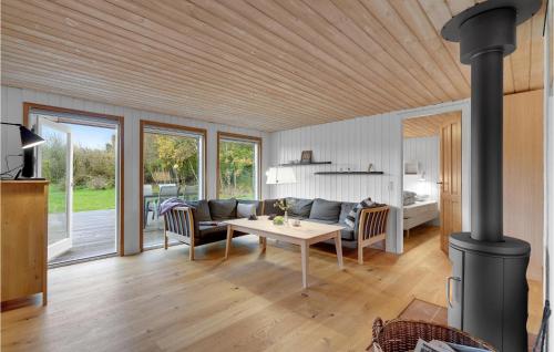 a living room with a couch and a table at Cozy Home In Herning With Sauna in Herning