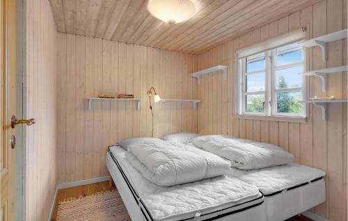 a bed in a room with a window at Cozy Home In Herning With Sauna in Herning