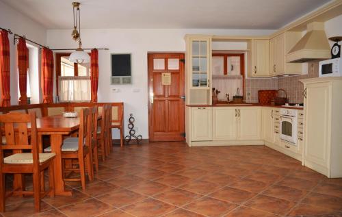 a kitchen with a table and a dining room at Jákó Ház in Bakonyjákó