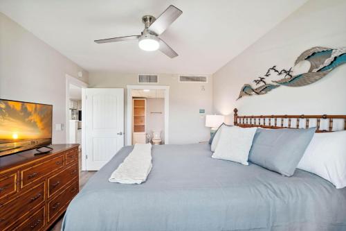a bedroom with a bed and a flat screen tv at Harbourside 7718- Premier in Clearwater Beach