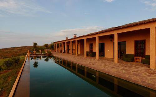 a building next to a body of water at Dar Imiri in Ourika