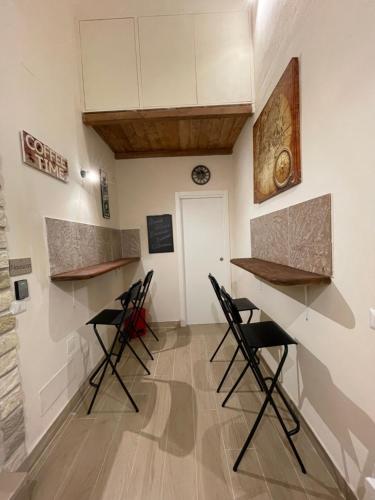 una habitación con 4 taburetes y un mostrador en Dimora Vesuviana, en Ercolano