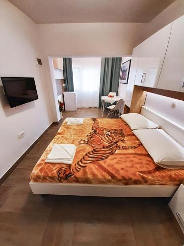 a large bed with a tiger painted on it in a bedroom at Apartment Nina in Rovinj