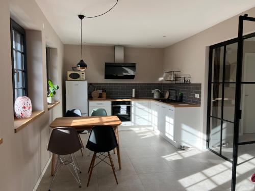 a kitchen with a table and some chairs in a room at Ferienwohnung Plan B in Lörrach