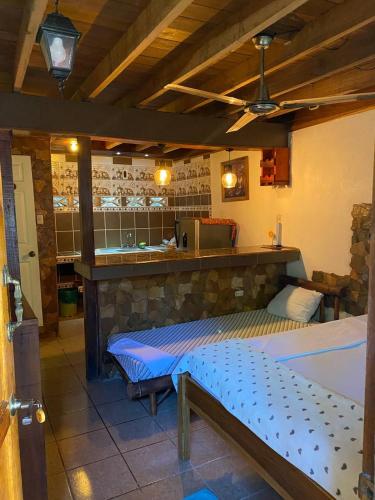 a bedroom with a large bed in a room at Hostal Cecilia in Puerto Viejo