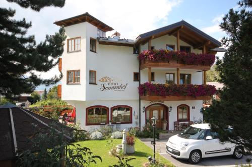 a building with a car parked in front of it at Hotel Sonnenhof - bed & breakfast & appartements in Innsbruck