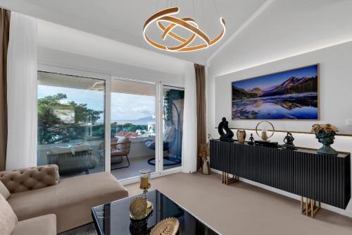 a living room with a couch and a large window at The Goldenhour Apartment in Makarska