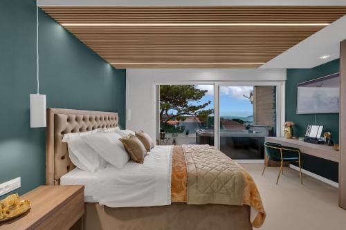 a bedroom with a large bed with a desk and a window at The Luxury Goldenhour in Makarska
