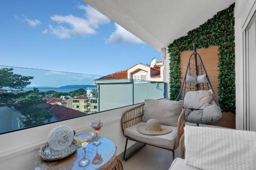 a balcony with a swing and a chair and a table at The Goldenhour Apartment in Makarska