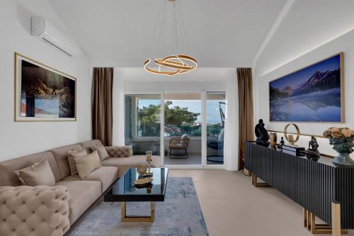 a living room with a couch and a table at The Goldenhour Apartment in Makarska