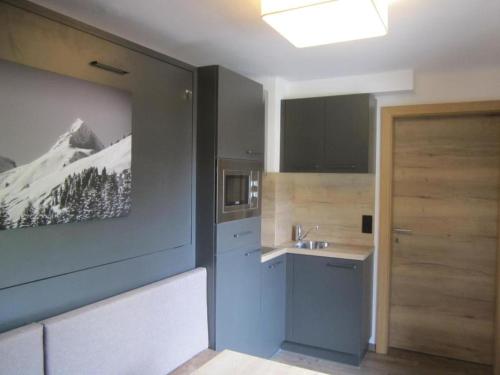 a kitchen with a sink and a counter top at Haus Kohlbründl in Saalbach-Hinterglemm