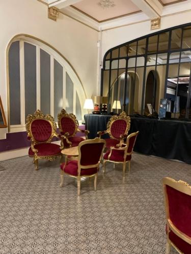 a group of chairs and a table in a room at Salon Boyer in Épernay