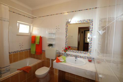 a bathroom with a toilet and a sink and a tub at VILLA EBER - independent 1 & 2 bedroom apartments, pool, air con, fast Wi-Fi, near old town of Albufeira and beaches in Albufeira