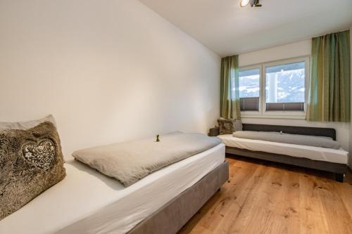 a bedroom with two beds and a window at Berg Apartment-Berg im Drautal in Berg im Drautal