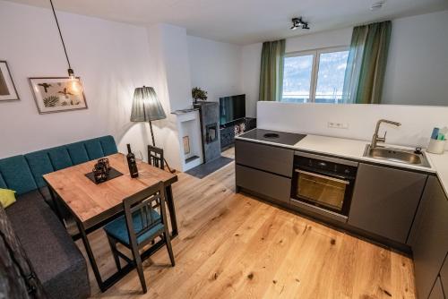 a kitchen and living room with a table and a sink at Berg Apartment-Berg im Drautal in Berg im Drautal