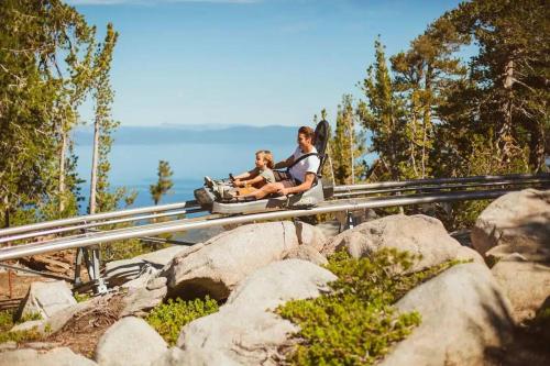 a woman and a child on a roller coaster at Ski In/Out - Zalanta - Great Location- 2 Hot Tubs - Heated Pool in South Lake Tahoe