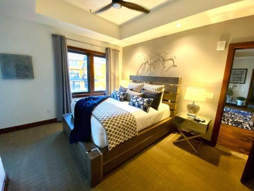 a bedroom with a large bed and a window at Ski In/Out - Zalanta - Great Location- 2 Hot Tubs - Heated Pool in South Lake Tahoe