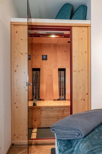 a bedroom with a wooden closet with a mirror at Berg Apartment-Berg im Drautal in Berg im Drautal