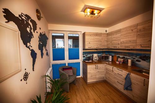 a kitchen with a mural of a world on the wall at Dom Wypoczynkowy Anna - opcjonalnie śniadania w Starej Piekarni in Kołobrzeg