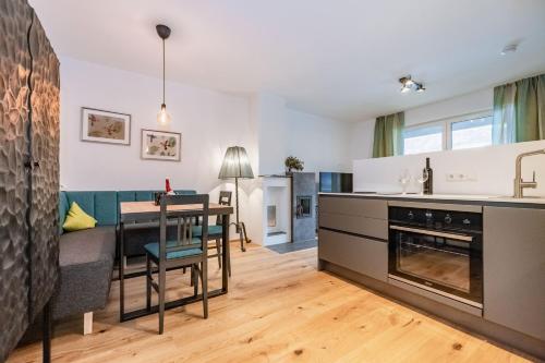 a kitchen and living room with a table and a couch at Berg Apartment-Berg im Drautal in Berg im Drautal