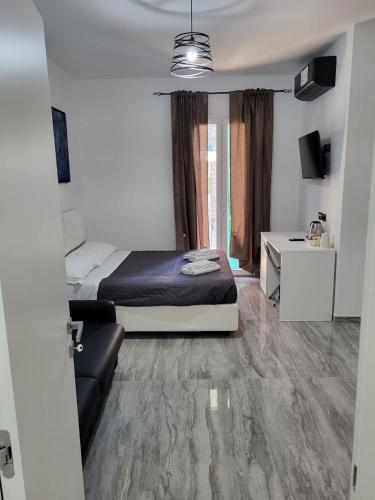 a bedroom with a bed and a desk and a bed sidx sidx sidx at Dimore Pietrapenta Apartments, Suites & Rooms - Via Lucana 223, Via Piave 23, Via Chiancalata 16, Vico Fornaci 9 in Matera