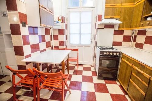 a kitchen with a checkered floor at Center apartment 5 private room for 19 people in Budapest