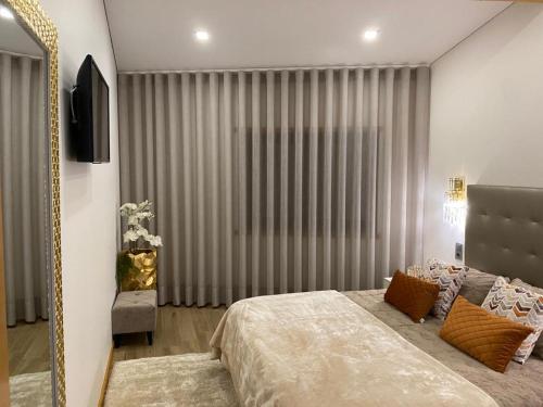 1 dormitorio con cama y ventana grande en Casinha da Eira en Esposende