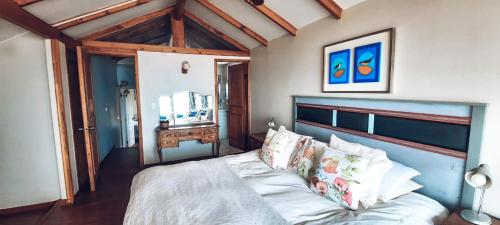 a bedroom with a large bed with a blue headboard at Casa Sto. Domingo Frente Al Mar in Santo Domingo