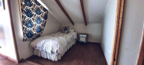 a small bed in a small room with a mirror at Casa Sto. Domingo Frente Al Mar in Santo Domingo