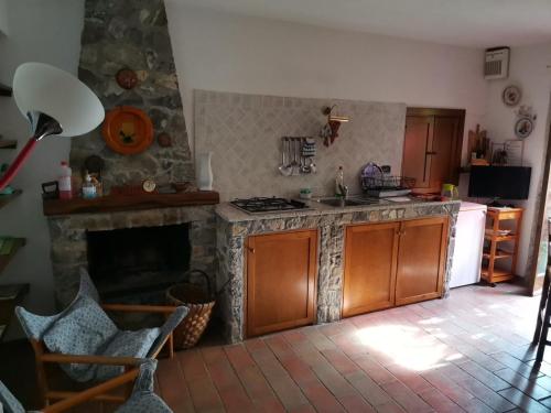 a kitchen with a stove and a fireplace at Cà Feddia in Bagnone
