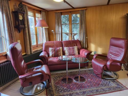 a living room with a couch and two chairs and a table at Apartments Saba & Jona in Uetendorf