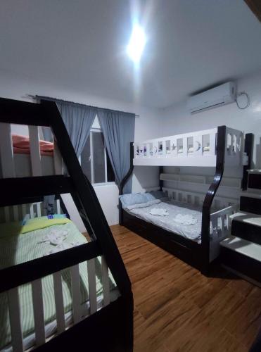 a room with two bunk beds and a staircase at Bungalow in Holidays Beach Resort in Bolinao