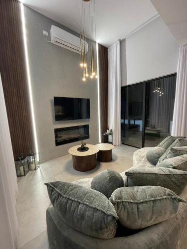 a living room with a couch and a table at Dian’s suits in Gita