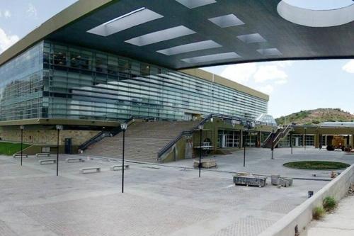 a large building with a staircase in front of it at Ubicación ideal en Ciudad de Neuquén. in Neuquén