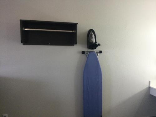 a blue tie hanging on a wall next to a window at Americas Best inn in Muskogee