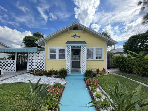 a yellow house with a star on the front at Seahorse Bungalow in St Pete Beach