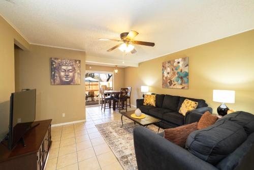 a living room with a couch and a tv at Stylish Townhome with Shared Pool Access in Gated Complex in San Antonio