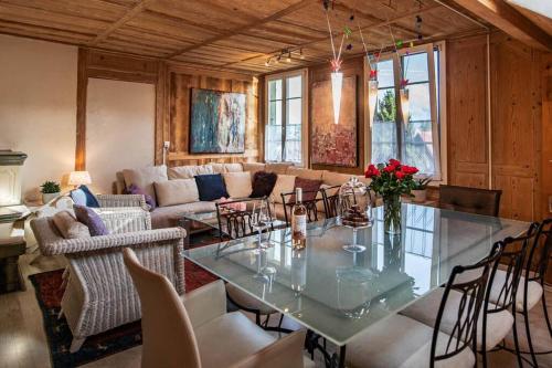 a living room with a glass table and chairs at Hadassa Apartments Navah in Uetendorf