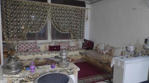 a living room with a couch and a table at Villa familys in Fez