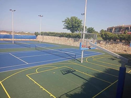 a tennis court with two tennis nets on it at Neot Golf, Ziv's Place in Caesarea