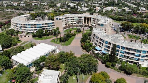 an aerial view of a city with buildings at Neot Golf, Ziv's Place in Caesarea