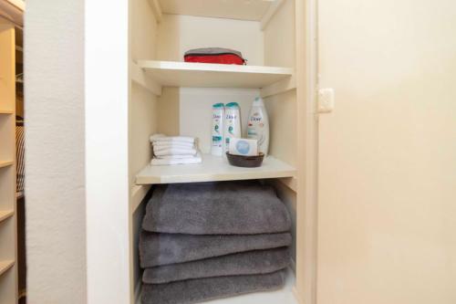 a walk in closet with towels and products in it at Stylish Townhome with Shared Pool Access in Gated Complex in San Antonio