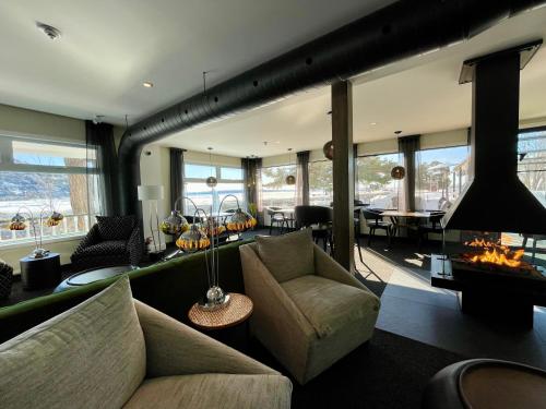 a living room with a couch and a fireplace at Domaine Belle Plage in Baie-Saint-Paul