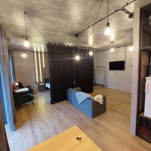 a living room with a couch and a stage at Loft city center in Poltava