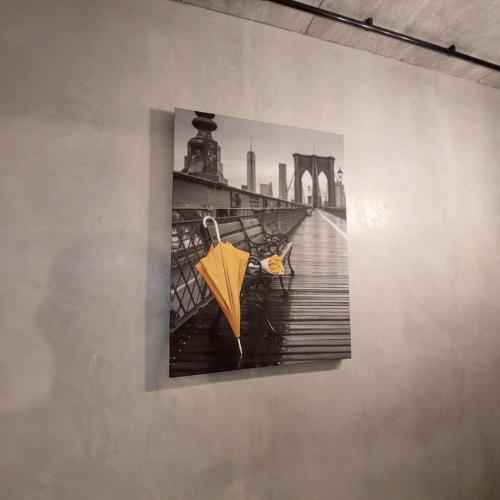 a painting of a bridge with an umbrella on a wall at Loft city center in Poltava